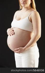 Close Up Portrait Of Pregnant Woman On Black Background