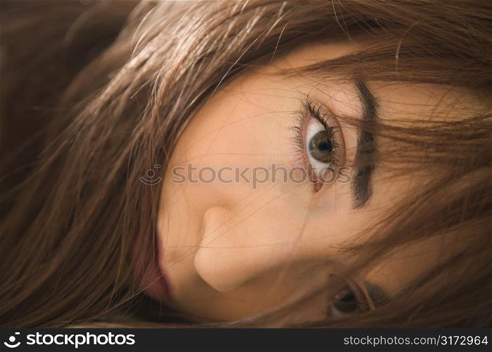 Close up portrait of pretty brunette young Caucasian woman making eye contact.