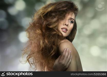 close-up portrait of seductive woman in sensual pose with naked shoulders and crazy bushy hair-style