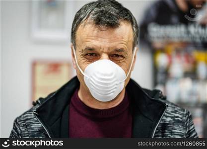 Close up portrait of senior caucasian man wearing face protective mask to protect from virus against flu anti bacteria protection health issues epidemic front view