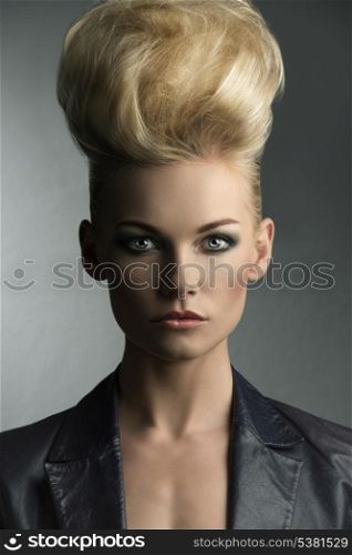 close-up portrait of sexy blonde girl with modern style, fashion hair-style and leather jacket, looking in camera