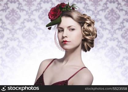 close-up portrait of sexy fashion blonde girl posing with elegant romantic hair-style with red roses, red sexy dress and heart shaped lipstick