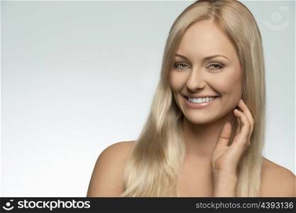 close-up portrait of smiling blonde woman with smooth hair, clean skin and fresh style. Beauty shoot