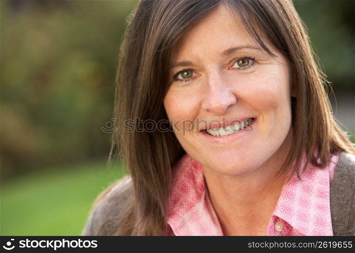 Close Up Portrait Of Smiling Brunette Woman Outdoors
