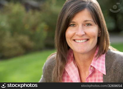 Close Up Portrait Of Smiling Brunette Woman Outdoors