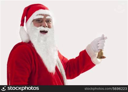 Close up portrait of smiling Santa Claus holding bell against white background