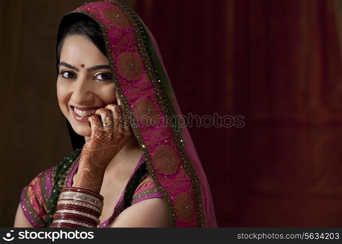 Close-up portrait of smiling young bride