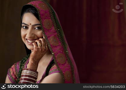 Close-up portrait of smiling young bride