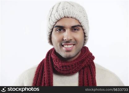 Close-up portrait of smiling young man wearing woolen hat