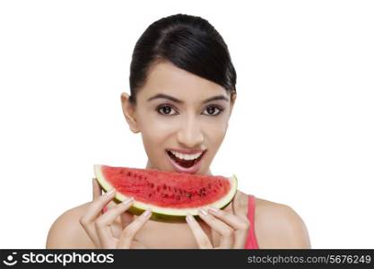Close-up portrait of smiling young woman with a slice of watermelon