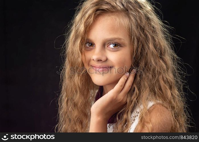 Close-up portrait of teenage girl on black background