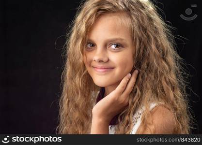Close-up portrait of teenage girl on black background