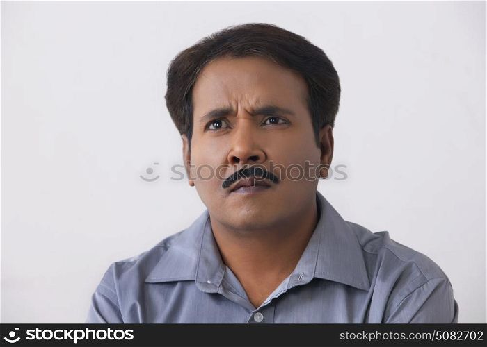 Close up portrait of tensed man on a white background.