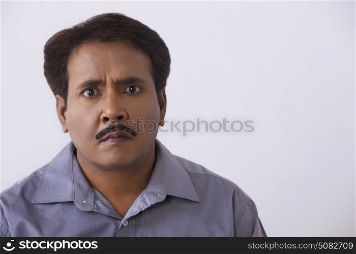 Close up portrait of tensed man on a white background.