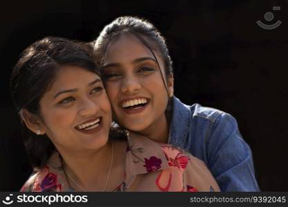 Close-up portrait of two smiling young women