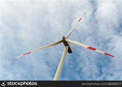 close-up portrait of wind turbine in blue sky