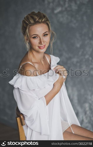 Close-up portrait of young beautiful girl.. Portrait of a young beautiful girl in a negligee 116.