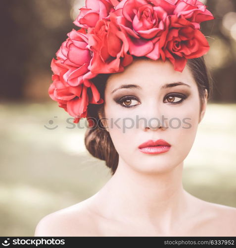 Close-up portrait of young beautiful japanese woman with pink and red flowers, model is an asian beauty