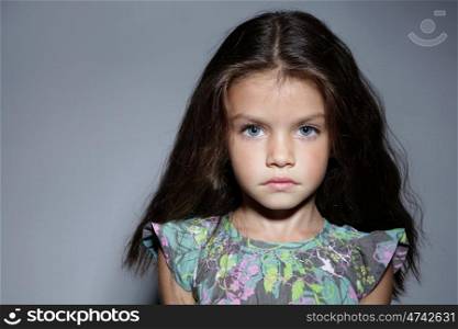 close up portrait of young beautiful little girl with dark hair