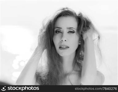 Close up portrait of young beautiful woman outdoor wind waving her hair, black and white image