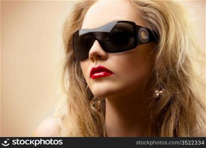close-up portrait of young blonde wearing stylish sunglasses