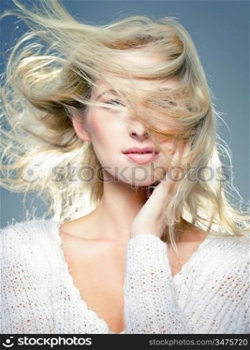 close up portrait of young blonde, with blowing hair