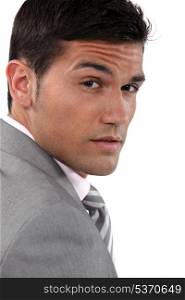 close-up portrait of young businessman frowning