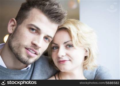 Close-up portrait of young couple in cafe