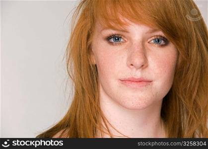 Close-up portrait of young red head woman.