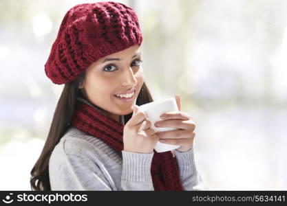 Close-up portrait of young woman holding tea cup
