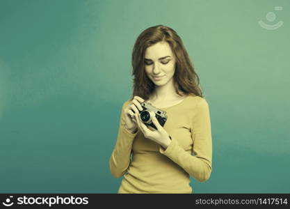 Close up Portrait young beautiful attractive ginger girl happy smiling with vintage camera and ready to travel. Blue Pastel Background. Copy space. Close up Portrait young beautiful attractive ginger girl happy smiling with vintage camera and ready to travel. Blue Pastel Background. Copy space.