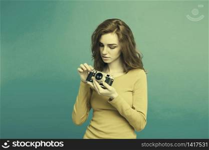 Close up Portrait young beautiful attractive ginger girl happy smiling with vintage camera and ready to travel. Blue Pastel Background. Copy space. Close up Portrait young beautiful attractive ginger girl happy smiling with vintage camera and ready to travel. Blue Pastel Background. Copy space.