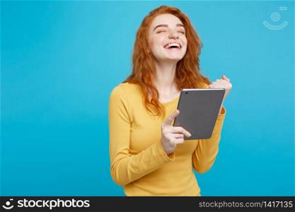 Close up Portrait young beautiful attractive redhair girl happy smiling on digital table with wining something. Blue Pastel Background. Copy space.
