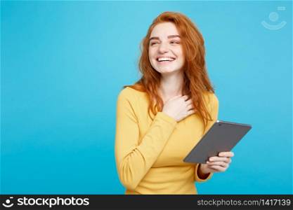 Close up Portrait young beautiful attractive redhair girl happy smiling on digital table with wining something. Blue Pastel Background. Copy space.. Close up Portrait young beautiful attractive tender ginger redhair girl happy smiling on digital table with wining something. Blue Pastel Background. Copy space.