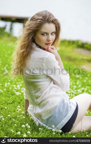 Close up Portrait, Young beautiful blonde woman posing outdoors in summer green park