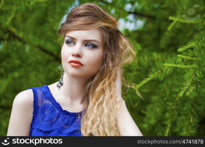 Close up Portrait, Young beautiful blonde woman posing outdoors in summer green park