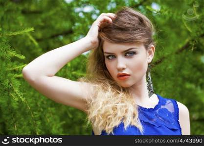 Close up Portrait, Young beautiful blonde woman posing outdoors in summer green park
