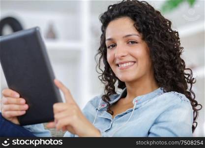 close up portrait young woman with tablet smiling
