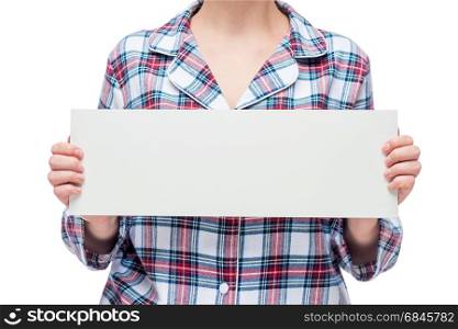 Close-up poster white in the hands of a woman dressed in plaid p. Close-up poster white in the hands of a woman dressed in plaid pajamas