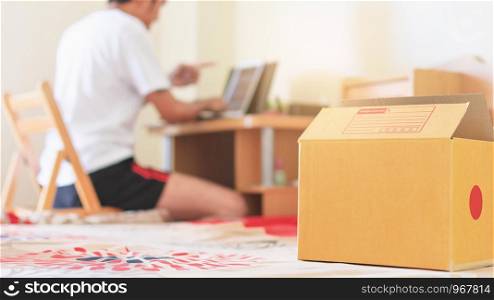 Close up Product box in home on man selling online marketing in room blurred background. shopping online and online sales concept