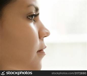 Close up profile of Hispanic young adult womans face.