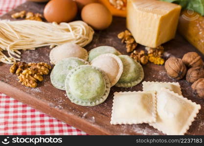 close up raw ravioli with ingredients wooden chopping board