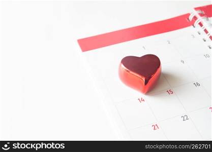Close up red heart on calendar on white background, Valentine concept