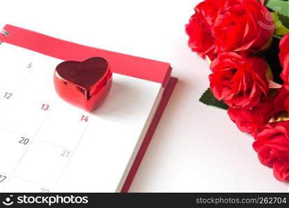 Close up red heart on calendar with red rose on white background, Valentine concept