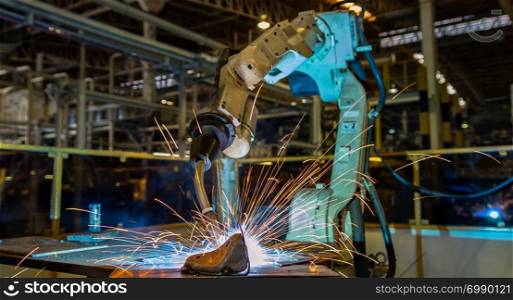 Close up robot welding repair steel part in factory