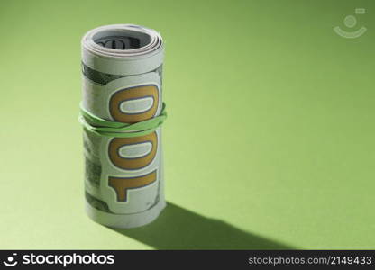 close up rolled up banknotes green background