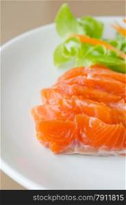 close up salmon sashimi with fresh salad. Salmon sashimi