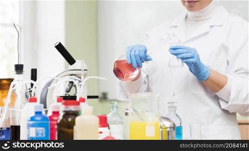 close up scientist holding flask