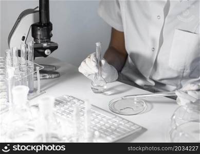 close up scientist holding glassware