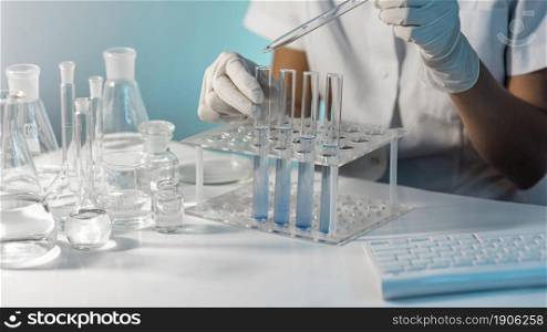 close up scientist holding tube pipette. High resolution photo. close up scientist holding tube pipette. High quality photo